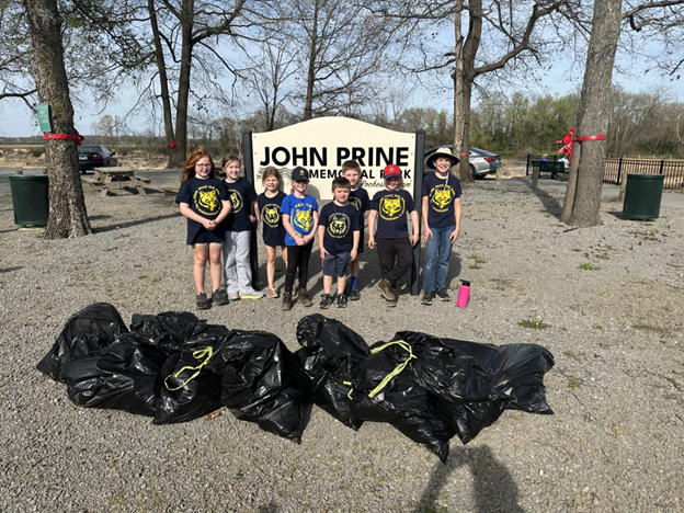 1. Cub Scout Pack 208 members collect litter along the walking paths at John Prine Memorial Park during their annual clean-up project. PHOTO | Submitted